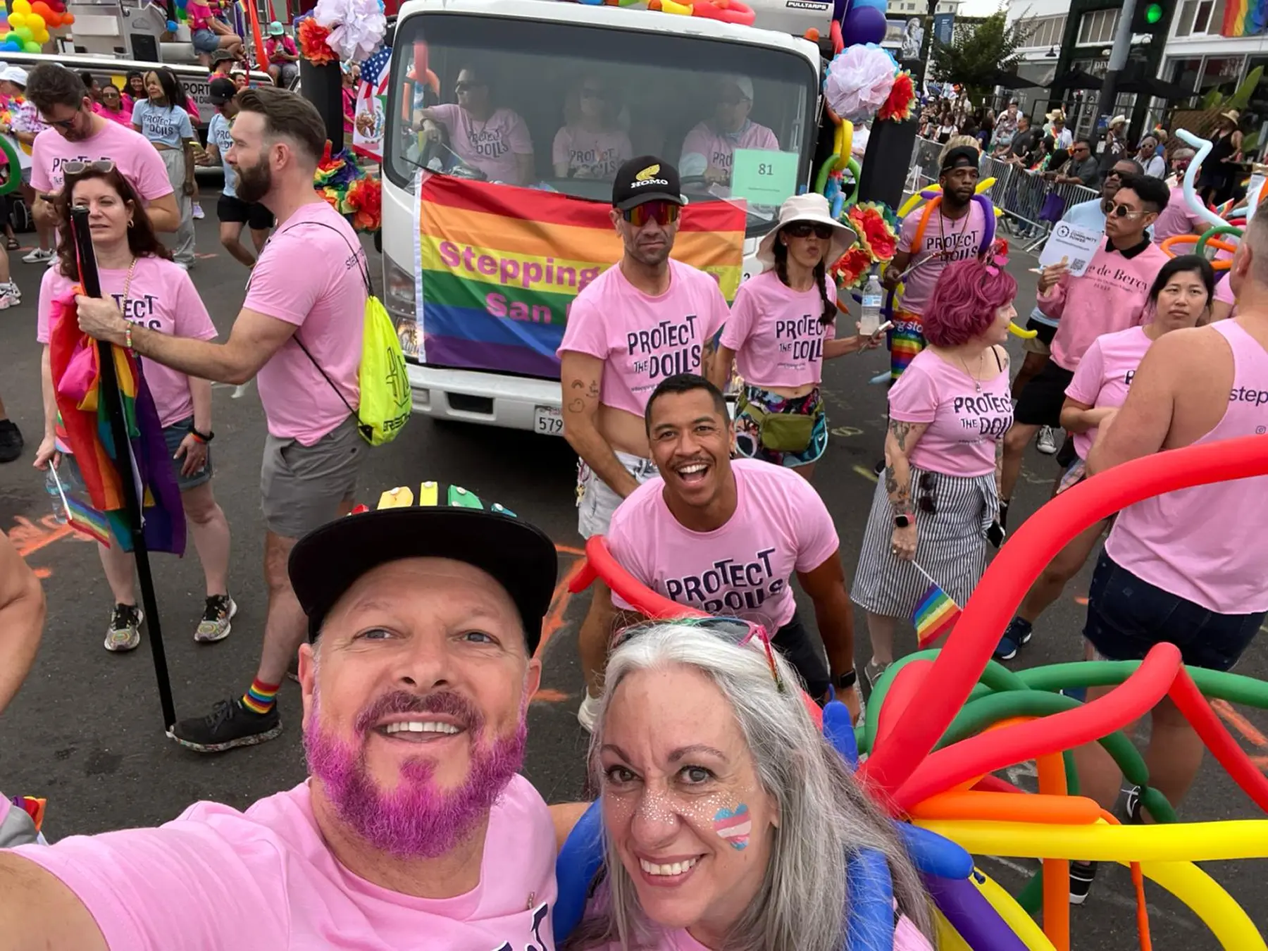 Stepping Stone community in Protect the Dolls shirts marching at San Diego Pride